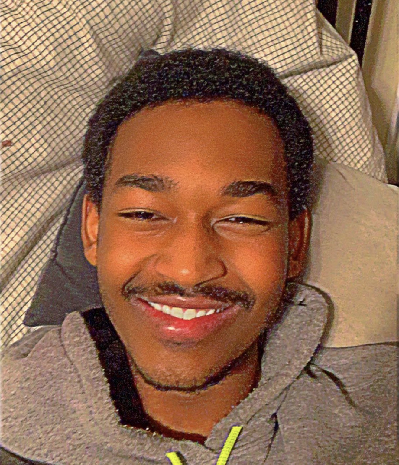 TJ smiling warmly at the camera